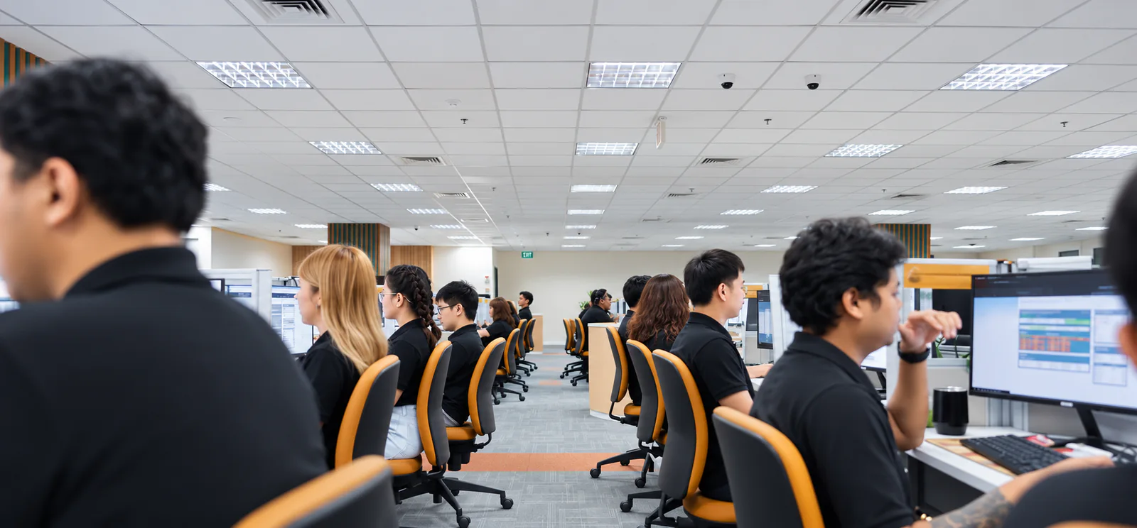 CF team members working at computer stations across the operations floor