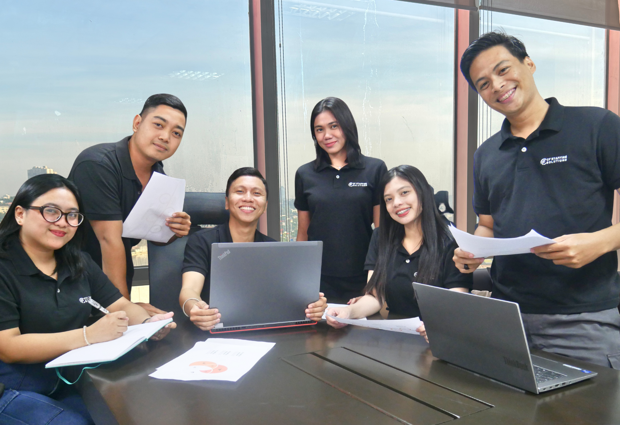 CF Outsourcing Solutions team collaborating in a modern office – professional outsourcing services in the Philippines for U.S. clients in IT, healthcare, and customer support. We are the top outsourcing company in the Philippines.